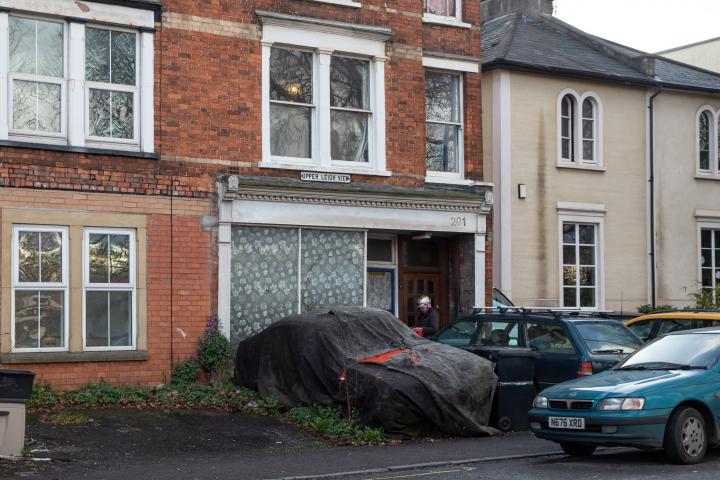 I presume it used to be a shop. Under the ragged tarpaulin is, I think, a Ford Consul Capri, and in the past there's been a later Ford—actual—Capri...