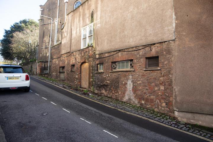 A homeless guy used to live in that doorway. I don't know if the boarding up coincided with the religious order that used to run Emmaus House as a...