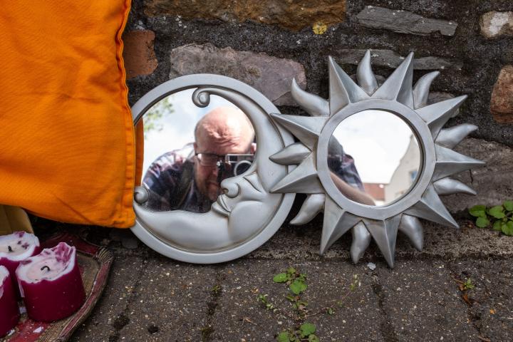 Either this was a makeshift altar for something, or someone was having a clear-out.

My bald pate is brighter than both the sun and the moon, I not...