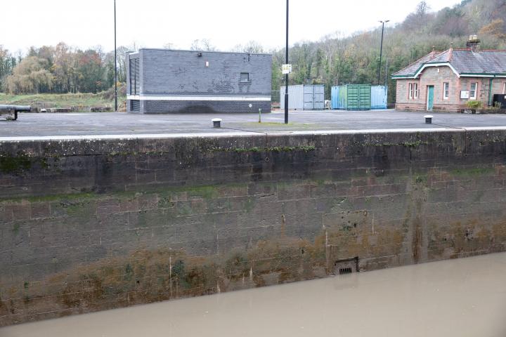 You can see how this sluice channel entrance in the side of the Entrance Lock wall is about level with the control wheel we saw on the far side—if...