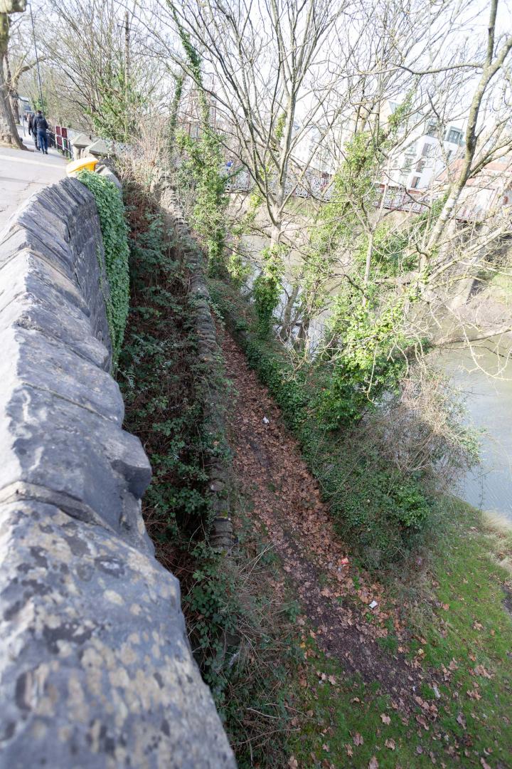 Leaning over the wall, we can see the overgrown steps from the bricked up gate leading down to the start of the ramp down to the ferry crossing.